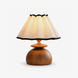 Accent table lamp with a black trimmed scalloped shade, plain ground
