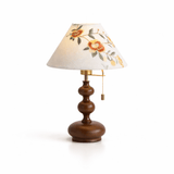 Floral shade lamp seen from an angle showing the stacked turnings