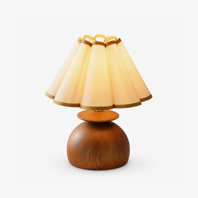 Accent table lamp with a scalloped cream shade on a rounded wood base