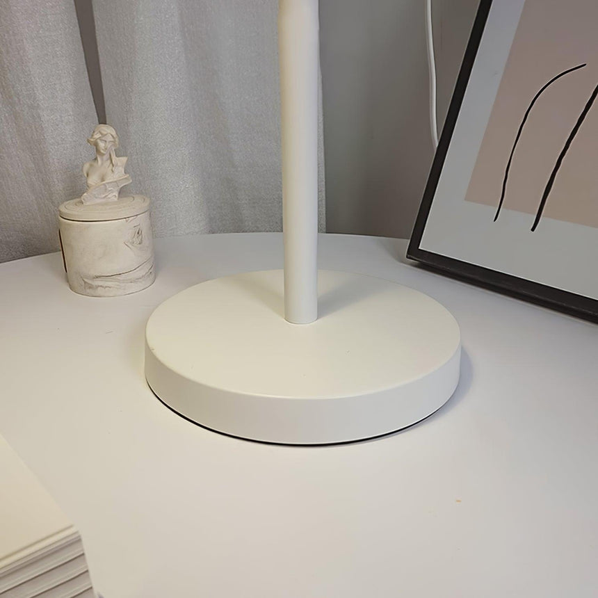 Close view of the low round metal foot and the white steel stem