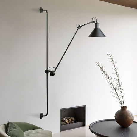 The arm reaching over a fireplace beside a green sofa and a round table