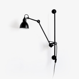 Swing arm wall lamp with a black cone shade, a jointed arm and a hanging cord