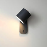 The black version lit, the cylinder head turned down against a warm wall