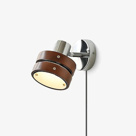 Walnut and chrome wall sconce with a tilting drum head, seen straight on