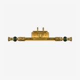 Long ornate brass bar with cast detail and a green stone bead at each end