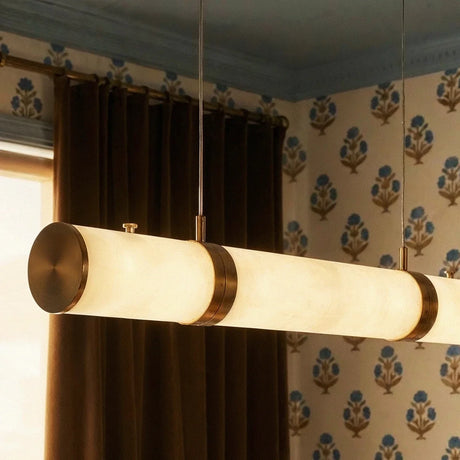 The lit stone tube at an angle, wallpaper and a curtain in the background