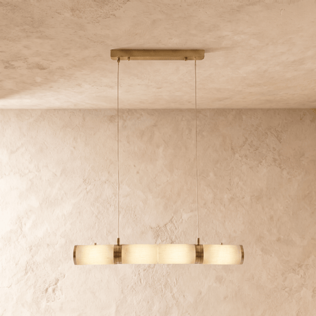 A shorter alabaster tube lit, brass collars between the stone cylinders