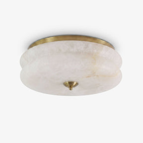 Alabaster flush mount ceiling light with a scalloped stone shade and a brass trim ring
