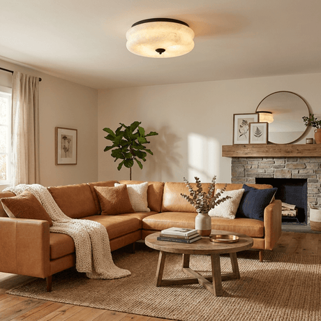 Scalloped alabaster ceiling light in a living room with a tan sofa and a fireplace