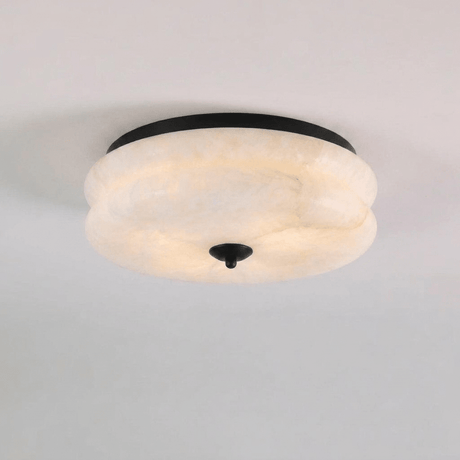 Black trim alabaster ceiling light seen close up against a plain background