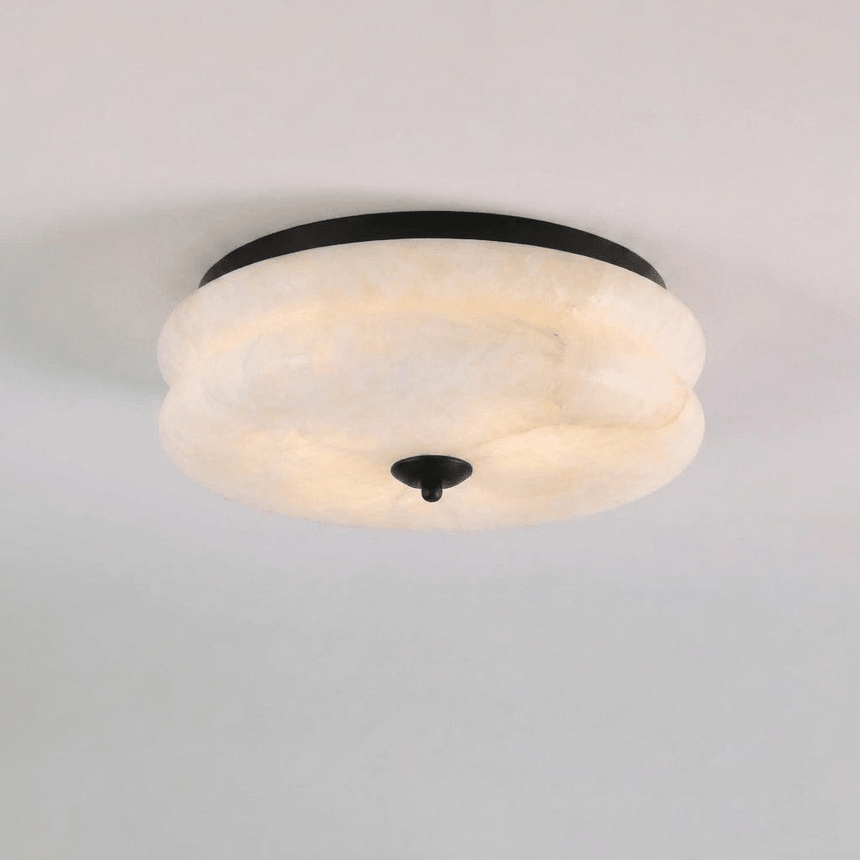 Black trim alabaster ceiling light seen close up against a plain background