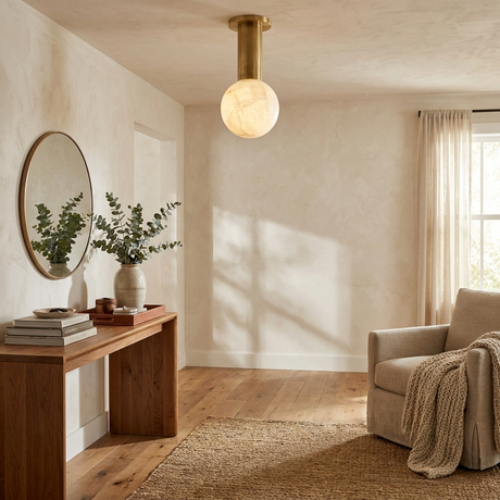 Alabaster sphere ceiling light in a hallway with a console, a mirror and a vase