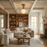 Alabaster sphere ceiling light below a coffered ceiling in a living room with bookcases
