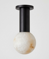 Black column alabaster sphere ceiling light shown close up against a plain background