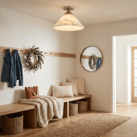 Alabaster cone ceiling light lit in an entry with a bench, a wreath and hooks