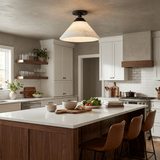 Alabaster cone ceiling light above a kitchen island with leather stools