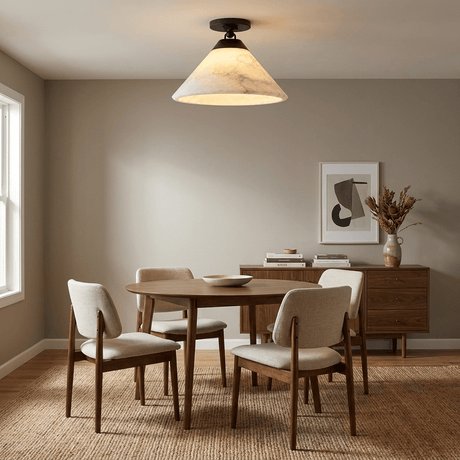 Alabaster cone ceiling light above a dining table with upholstered chairs and a sideboard