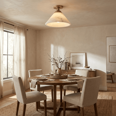 Alabaster cone ceiling light in a dining room with sheer curtains and pale chairs
