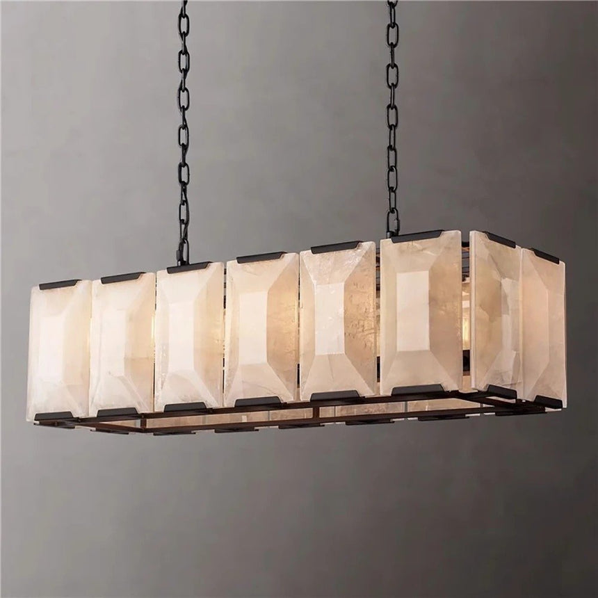 A black framed cage of faceted stone panels, lit, from a corner