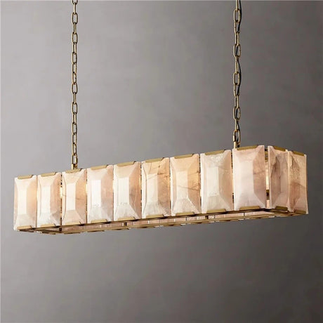 A brass framed cage of lit stone panels seen from one corner