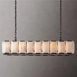 A rectangular stone cage in a dark frame hung on two chains