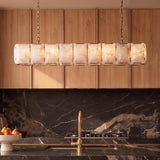 A lit stone cage above a kitchen counter with a marble backsplash