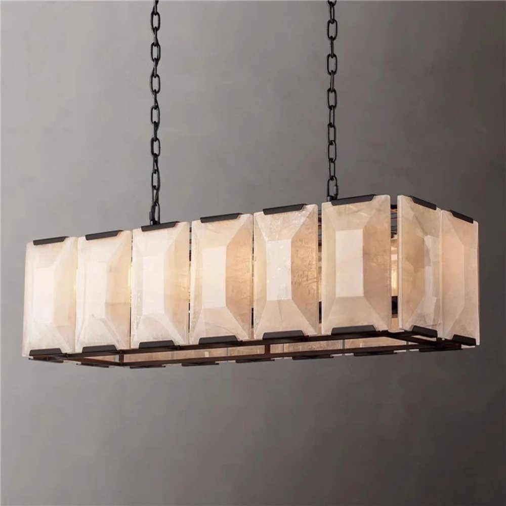 A long cage of faceted stone panels in a black frame on chains