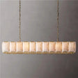 A long cage of faceted stone panels in a brass frame on chains