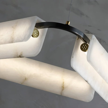 The copper pin and black arm joint that holds one alabaster bar in place