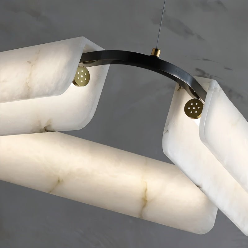 The copper pin and black arm joint that holds one alabaster bar in place