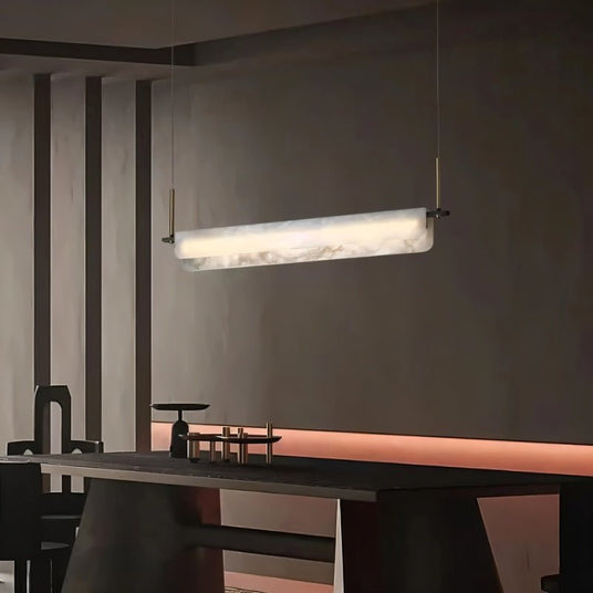 A lit stone bar above a long dark dining table in a room with timber walls