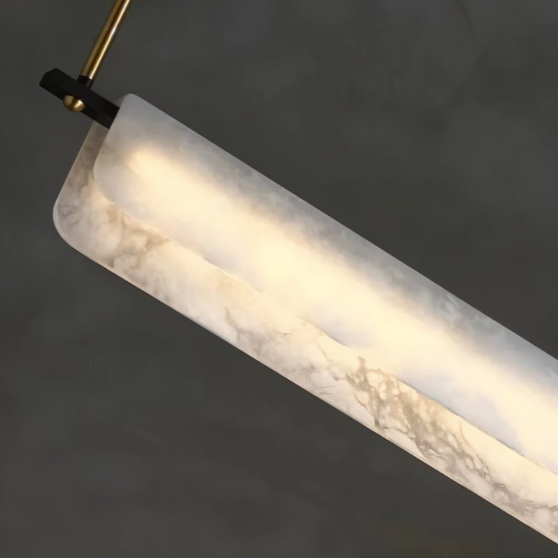 One lit bar at an angle, a copper pin at the top and veining across the stone