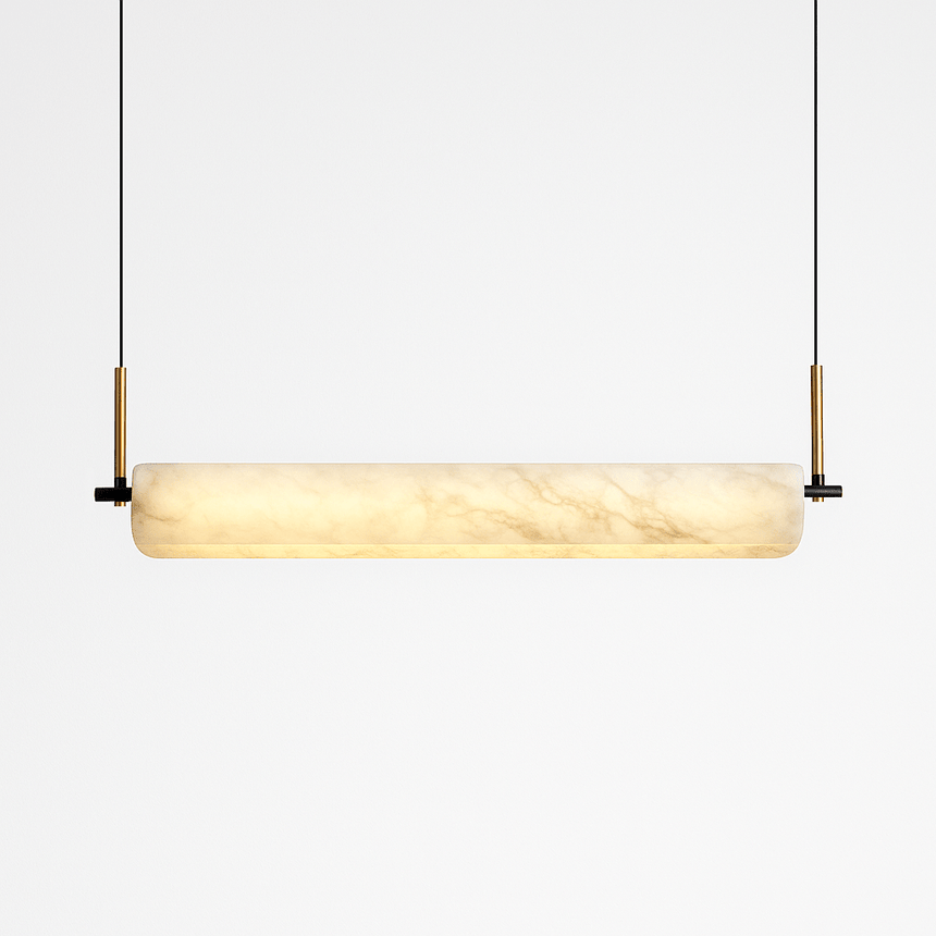 The same alabaster bar lit, the stone glowing warm from one end to the other