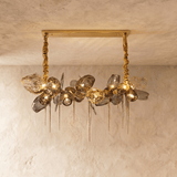The linear bar lit, amber petals alternating with clear and smoke glass