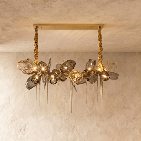 The linear bar lit, amber petals alternating with clear and smoke glass