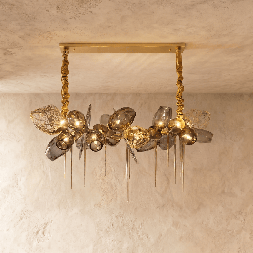 The linear bar lit, amber petals alternating with clear and smoke glass