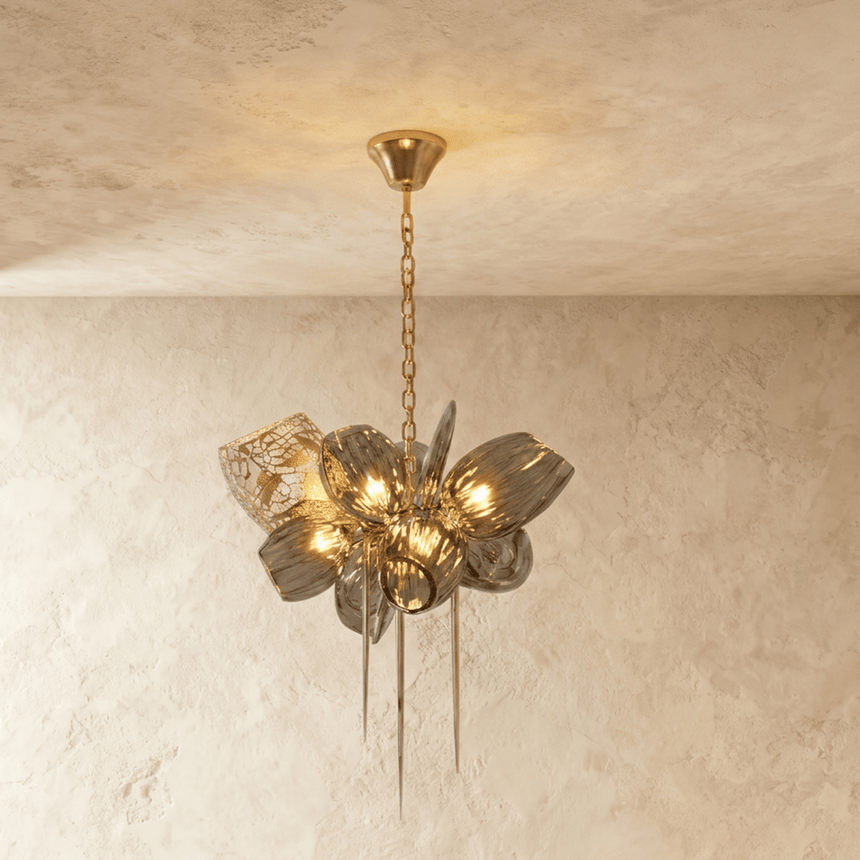 The small version lit, amber petals catching the light around a brass hub