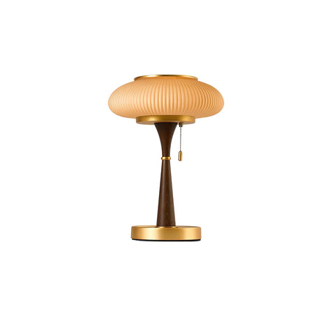 The amber glass cap and gold stem seen front on against plain gray