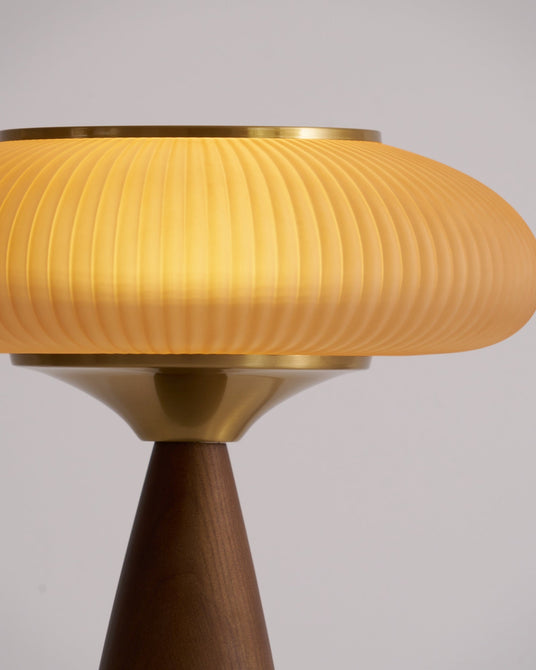 Close view of the flutes running around the lit amber glass shade