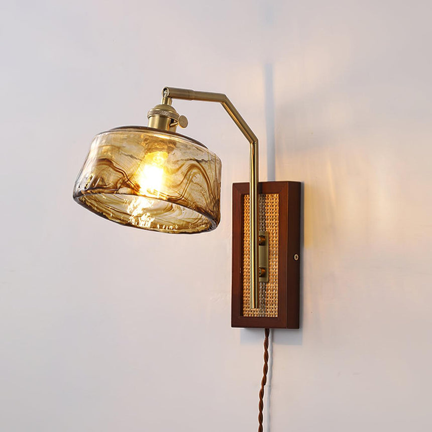 The amber drum glass shade lit on a plain wall