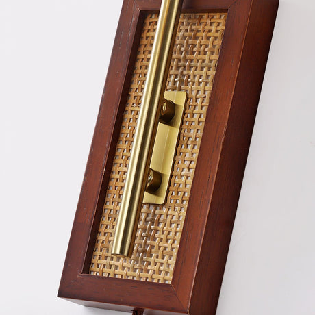 The walnut back plate with its cane inlay and the arm bracket, photographed close