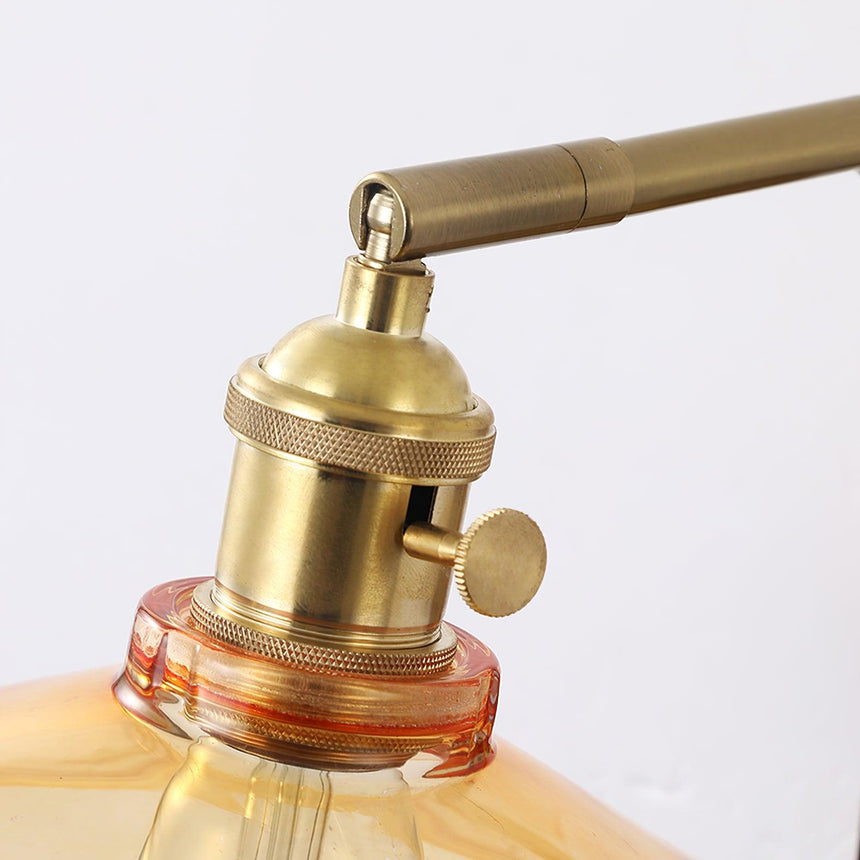 The copper socket with its turn switch above the amber glass, seen close