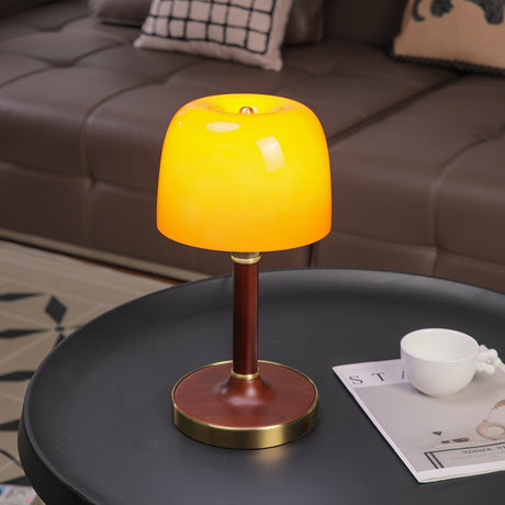 Amber table lamp lit brightly, the glass reading vivid orange
