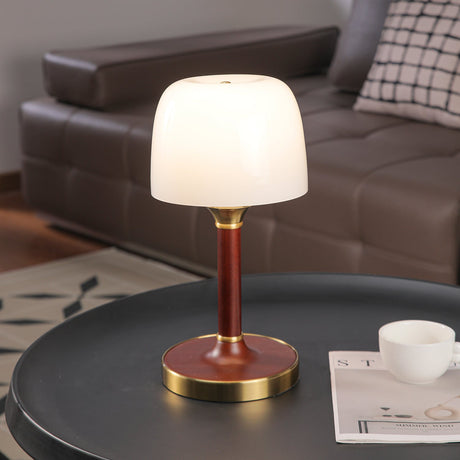 The white glass version unlit on a round dark table