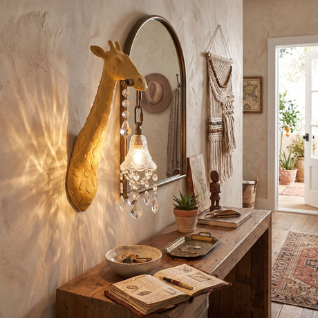 The yellow giraffe sconce lit above an entry table with a bowl and books