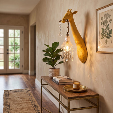 The yellow giraffe sconce lit above a hallway console with a plant and books