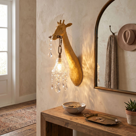 The yellow giraffe sconce lit beside an arched mirror above a wood table