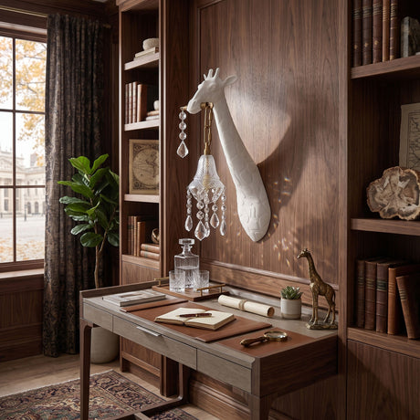 The white giraffe sconce above a desk in a study lined with wood bookshelves