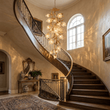 Brass branch chandelier beside a staircase under arched windows