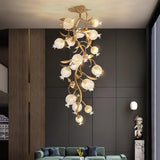 Brass branch chandelier in a dark room with a tall sculpture